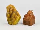 two pieces of carved soap sitting next to each other