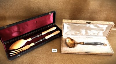 a box with a knife, spoon, and spoon rest in it