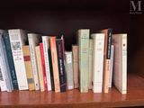 many books that are on a book shelf together