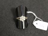 a ring that is sitting on a table with a price tag