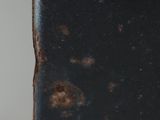 a close up of a black book with rust on it