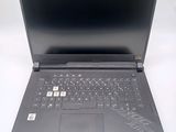 the laptop is open on a white surface with a black keyboard