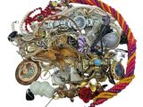a pile of assorted jewelry on a white surface