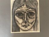 a drawing of a woman ' s face is shown in a black and white photo