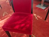 a red chair with a price tag on the back of it