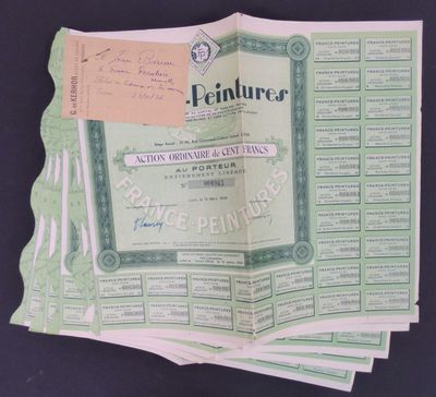 several green and white certificates are stacked on top of each other