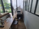 a long desk with a computer on it in a room