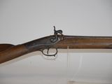 a close up of a rifle on display in a museum