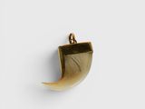 a close up of a horn shaped object on a white surface