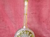 an image of a clear glass bottle with a yellow base
