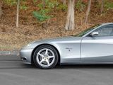 a silver sports car parked on the side of the road