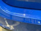 a close up of a blue car with a sticker on it