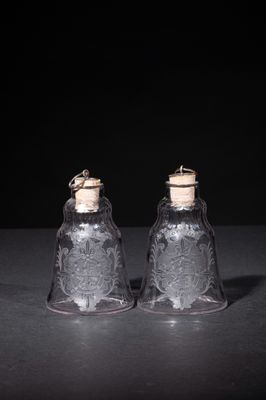 pair of clear glass salt and pepper shakers with cork stoppers