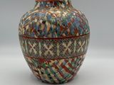 a vase that is sitting on a white surface