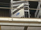 a picture of a man standing on a lift in a building