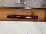 a baseball bat, a pair of shoes, and a pair of rings on a table