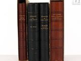 three books are lined up on top of each other on a table