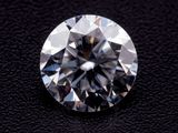 a close up of a diamond on a black surface