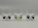 three shot glasses with black and white butterflies on them