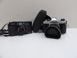 two cameras sitting on a table next to each other
