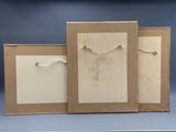 three pieces of cardboard with a string hanging from them on a table
