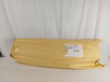 an image of a large yellow pillow on a white table