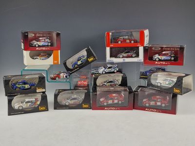 a lot of diecast cars in boxes on a table