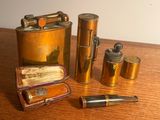 une petite flasque en laiton, un briquet et d'autres objets posés sur une table