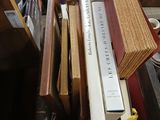 a lot of books that are stacked on top of each other