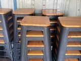 many stools that are stacked on top of each other