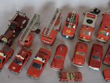 a lot of toy fire trucks and trucks on the table