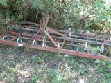 a plow that is sitting in the grass