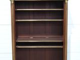 an image of a wooden bookcase with three shelves on top of it