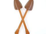 pair of brown leather handled shovels on white background