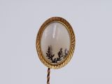 a gold stick with a picture of a tree on it