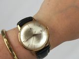 a woman ' s wrist with a watch on it