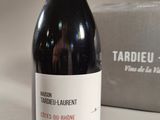 a bottle of wine sitting on a table next to a box
