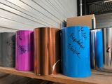 many different colored cans on a shelf with writing on them