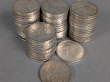 several stacks of silver coins sitting next to each other on a table