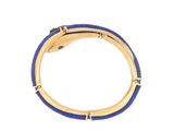 a close up of a gold and blue bracelet on a white background