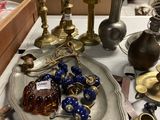a lot of antique items on a table in a store