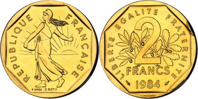 a gold coin with the image of a woman holding a basket of flowers