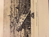 an open book with a drawing of a boat in the water