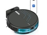 une photo d'un aspirateur robot avec un téléphone en arrière-plan
