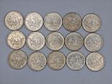 a bunch of silver coins sitting on top of a table