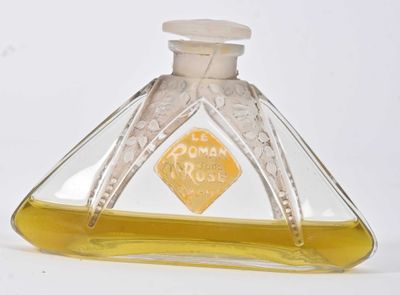 a glass bottle with a yellow label sitting on a white surface