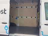 a white van with the door open and a sign on the side of the van