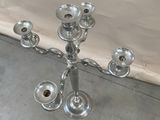 a silver candelab with five candles on it