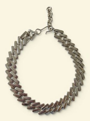 bracelet made of silver metal strips with a clasp on a white background
