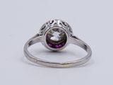 a close up of a ring with a purple stone in the center